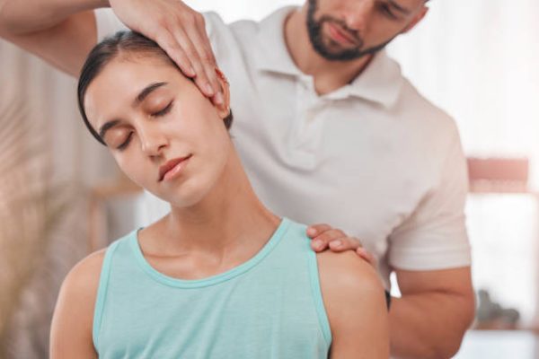 istockphoto-1447803707-612×612 Physiotherapy, neck pain and stretching with woman and doctor for healthcare, chiropractic or consulting. Massage, wellness or medical with man and patient exam for rehabilitation, healing or therapy